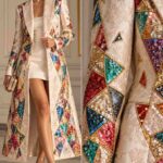 Model wearing a white lace coat with colorful geometric sequin embellishments