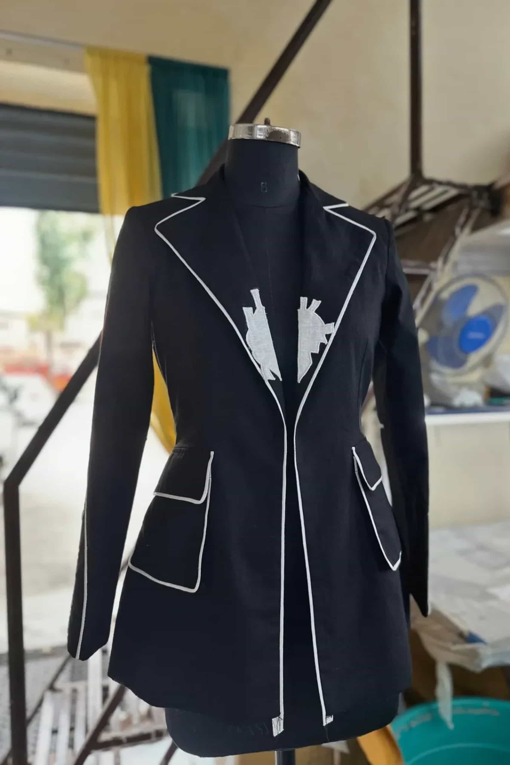 black tailored blazer with white piping and embroidered detailing