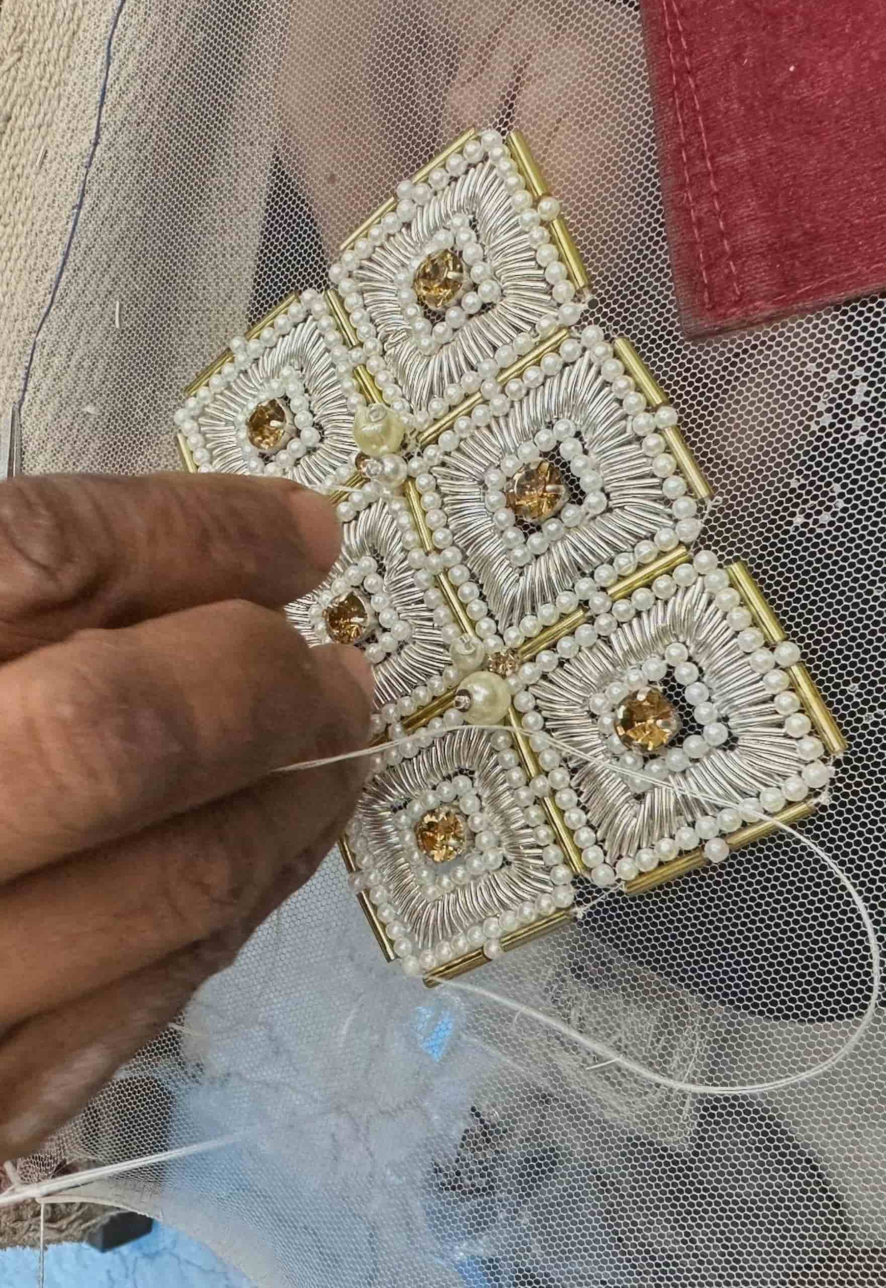 intricate silver and gold beadwork with pearl embellishments on sheer fabric